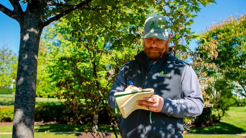 property manager with checklist for winter landscape management