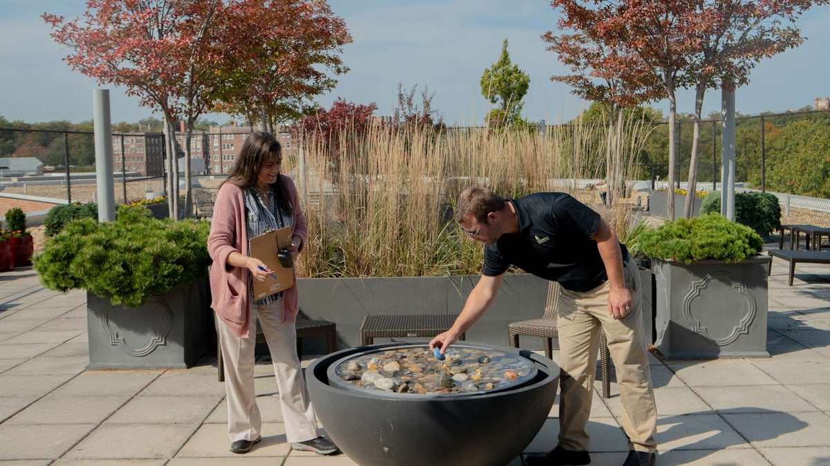 account manger meets with property manager on rooftop