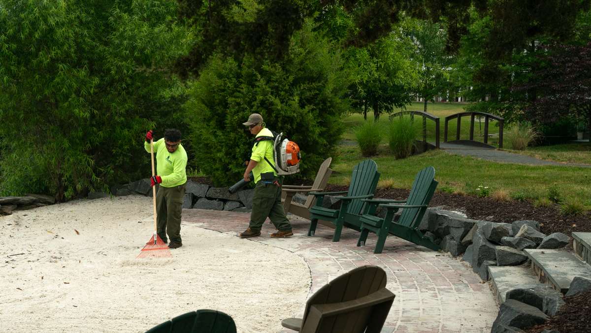 Loudoun Meadows HOA commercial landscaping crew raking beach blowing