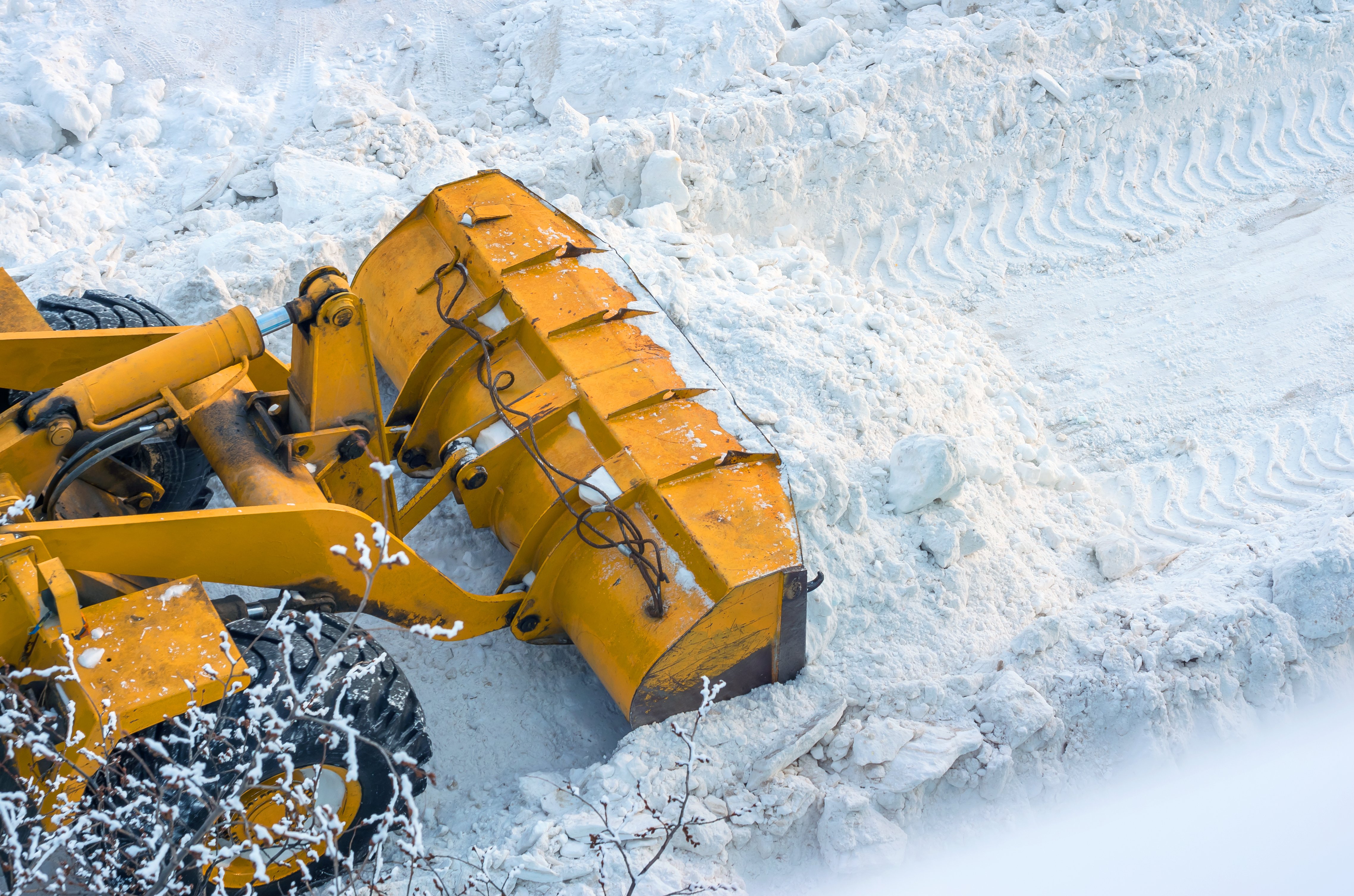 equipment pushes snow