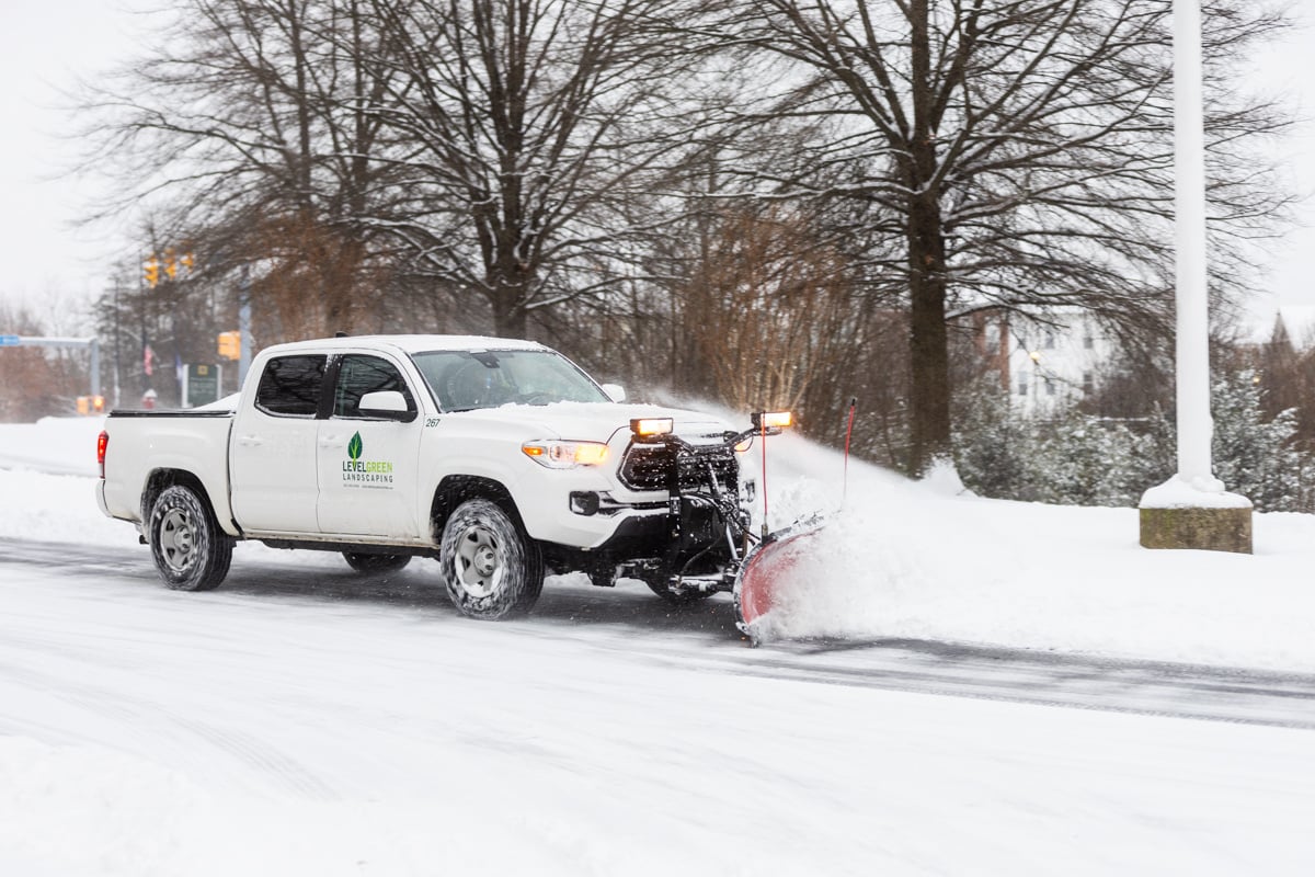 Commercial snow removal crew plowing snow 16