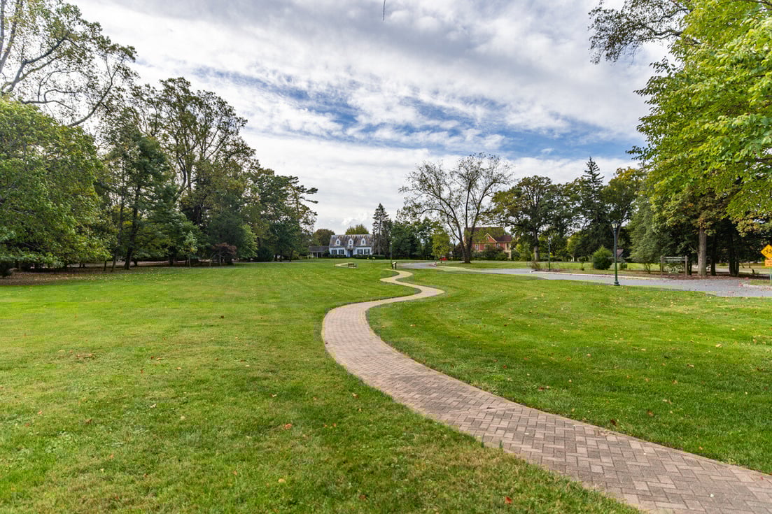 Chestnut HOA Large green grass community space paver sidewalk