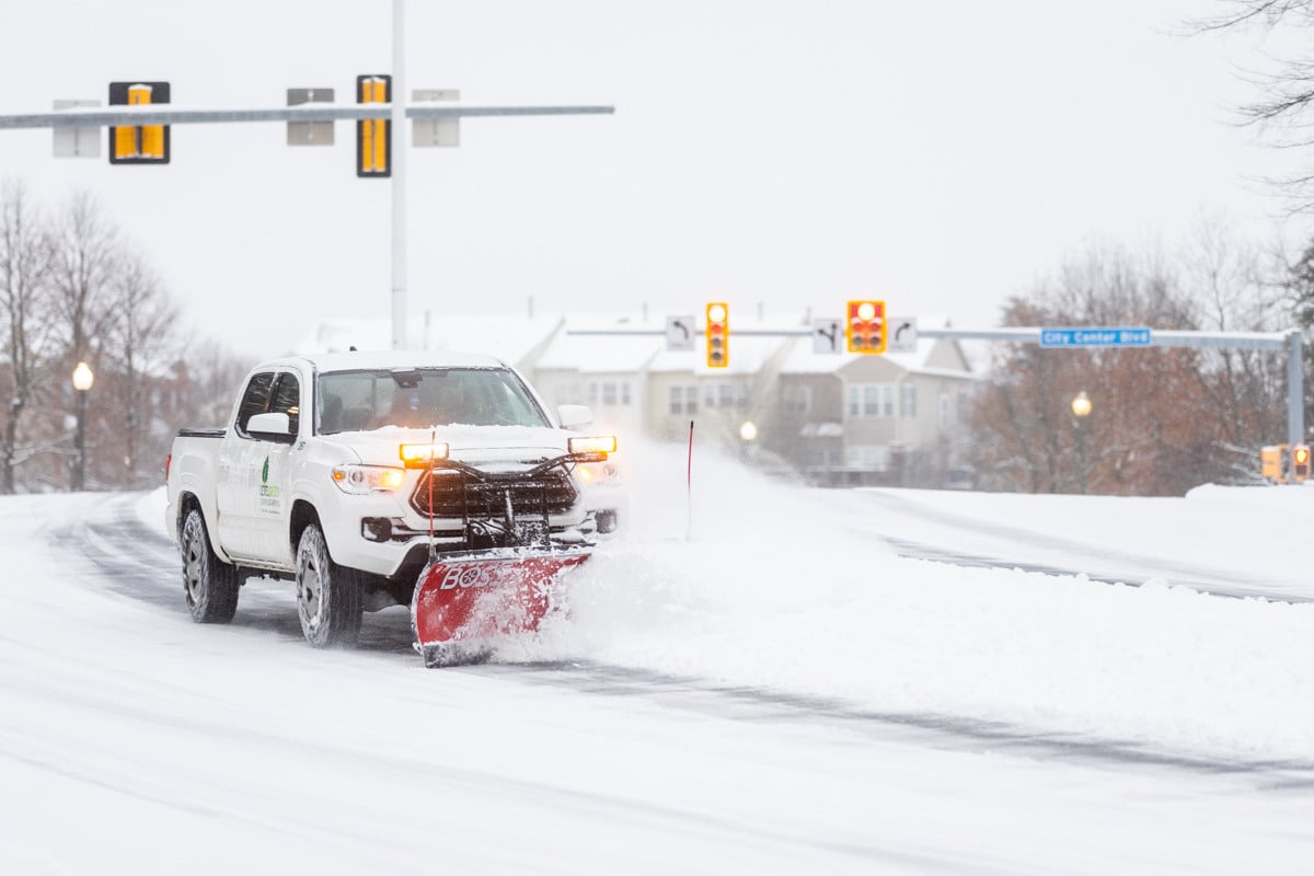 Commercial snow removal crew plowing snow 15