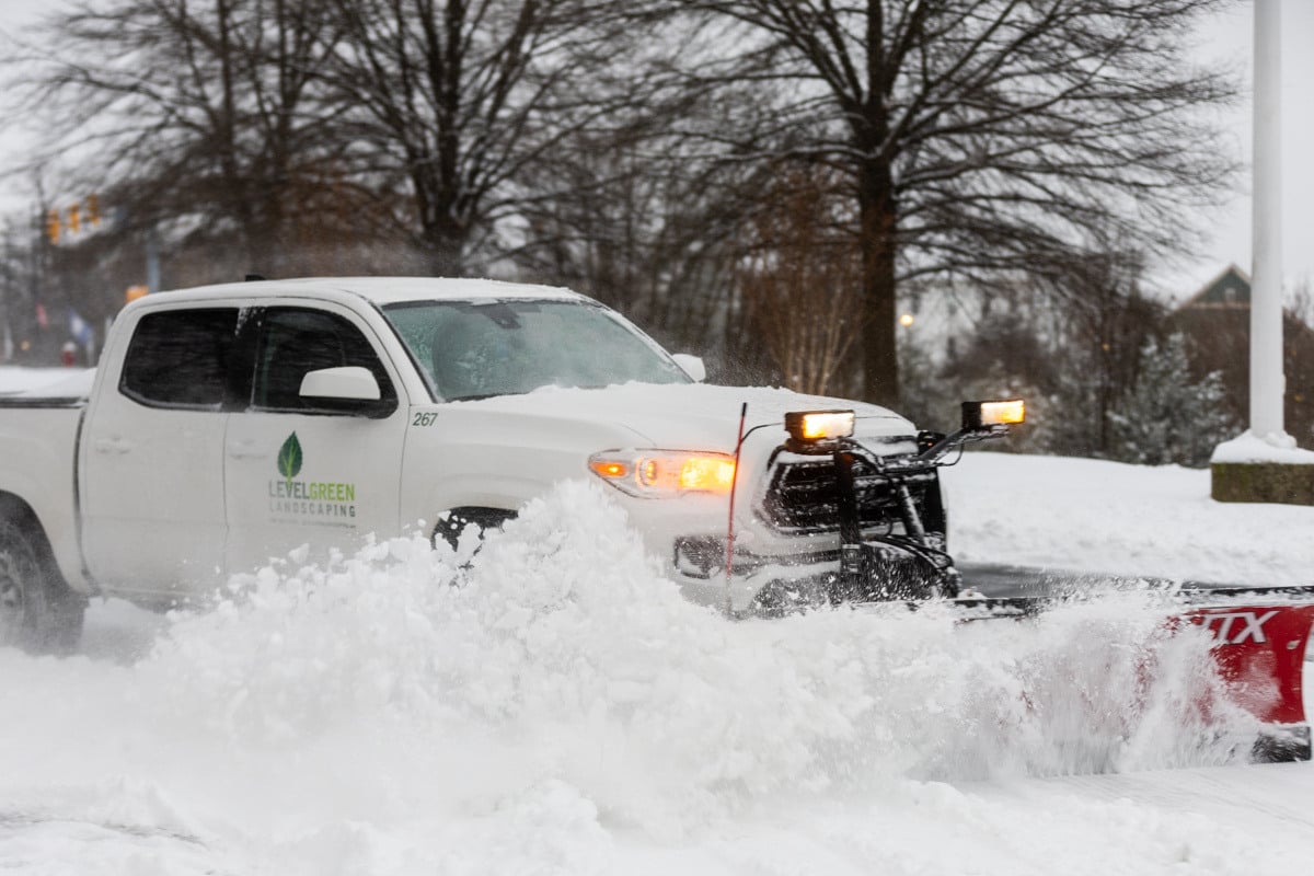 Commercial snow removal crew plowing snow 23