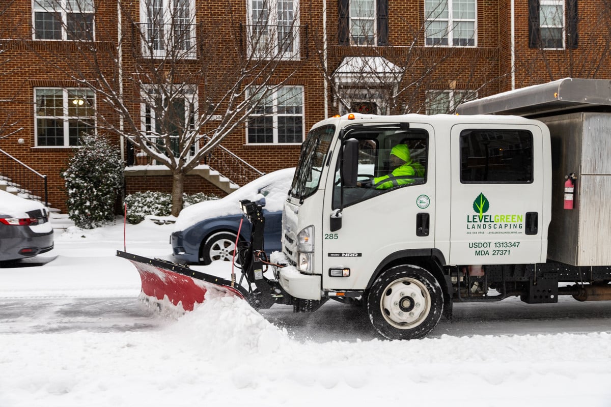 Commercial snow removal crew plowing snow 29