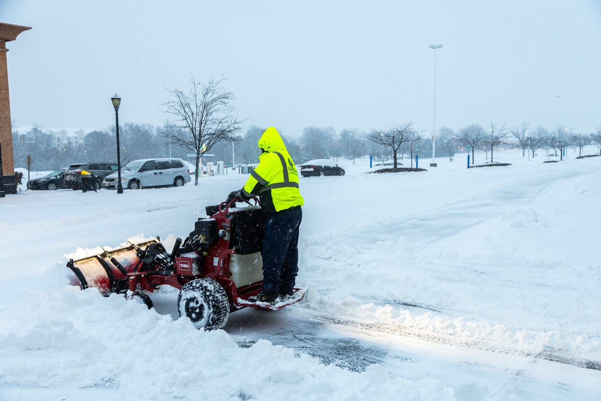 Commercial snow removal crew plowing snow 5