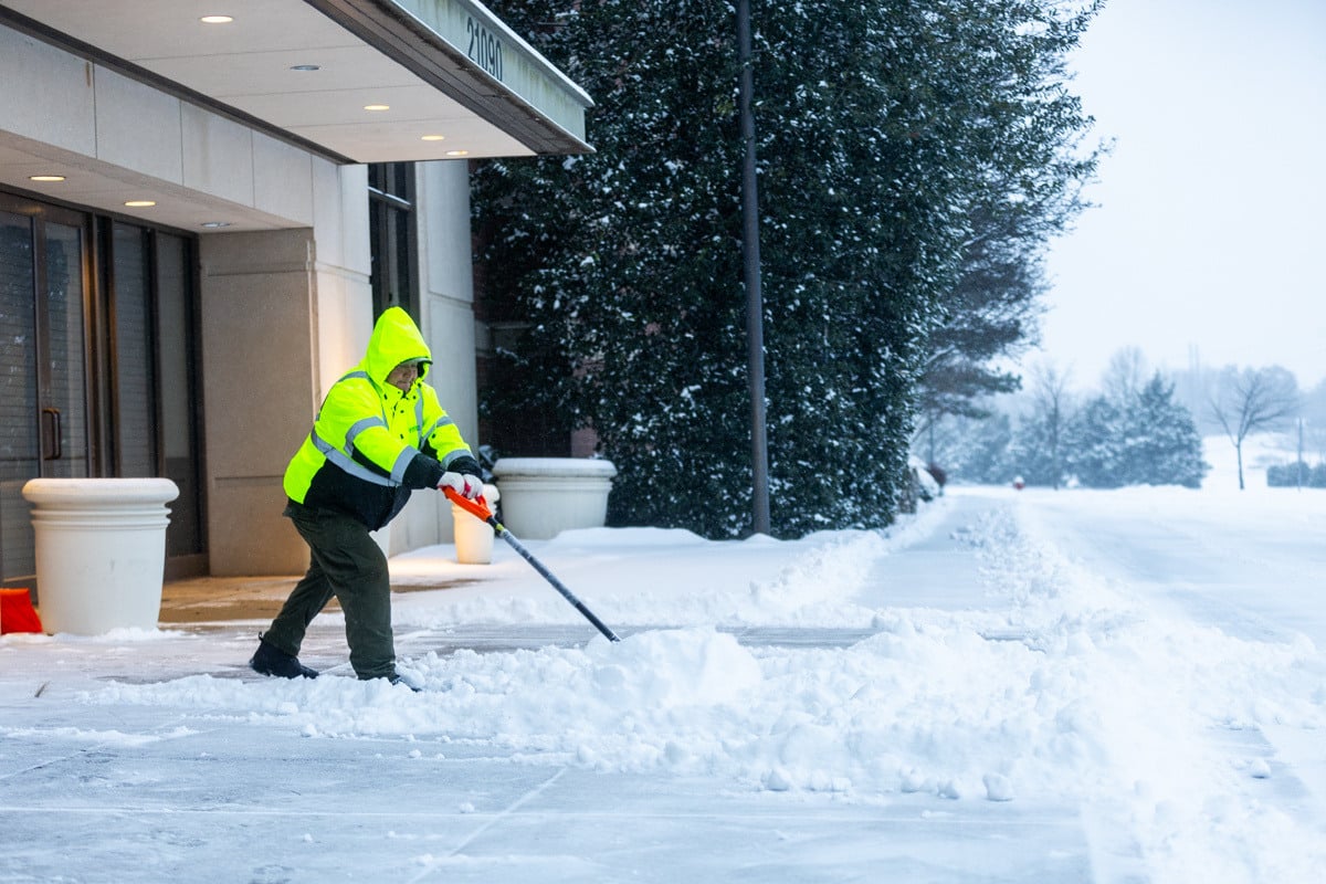 Commercial snow removal crew shoveling snow