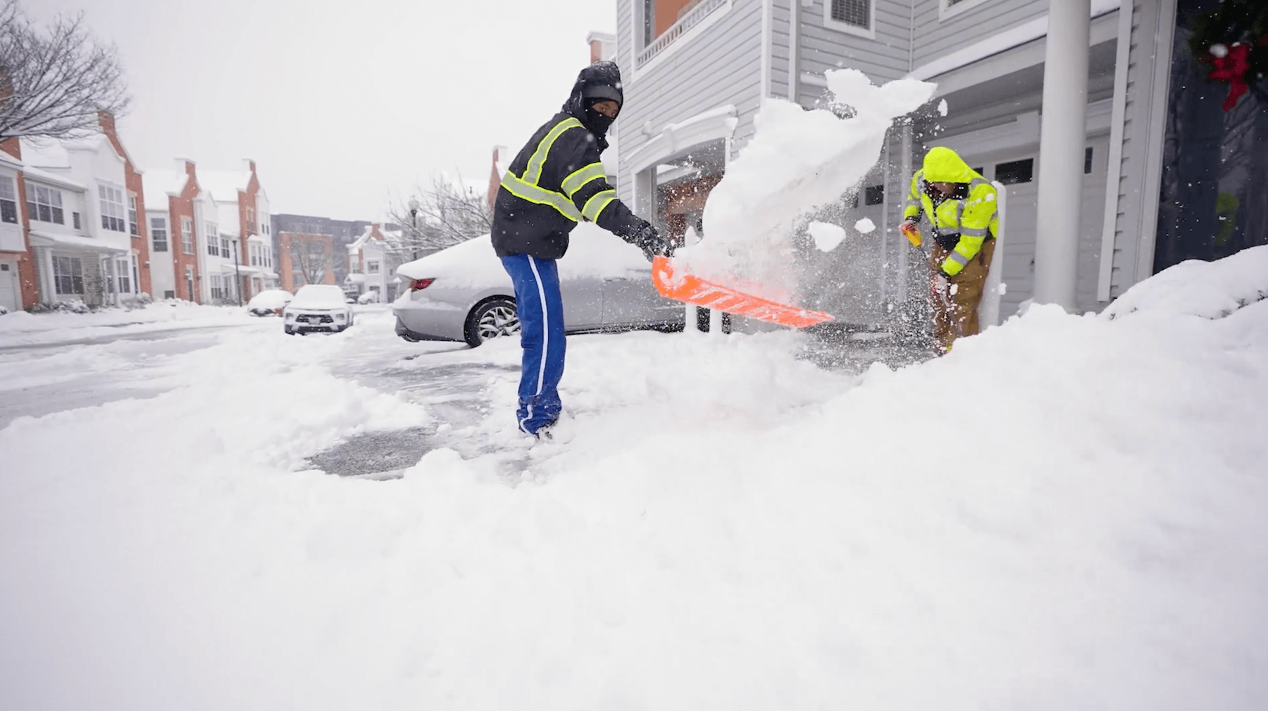 Crew Shoveling Snow on HOA Sidewalk