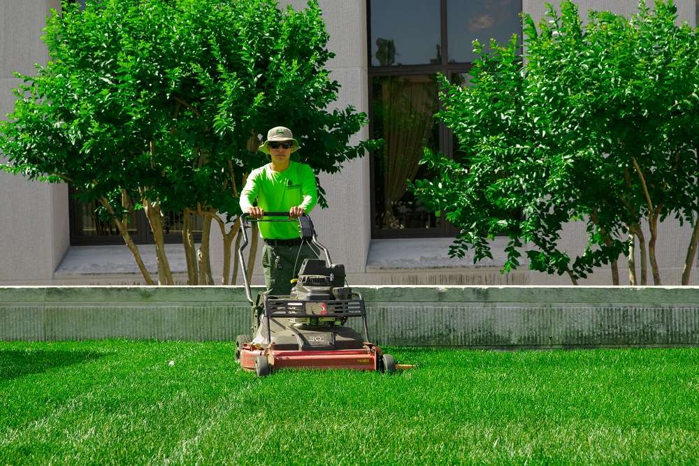 Grass being mowed on commercial landscape