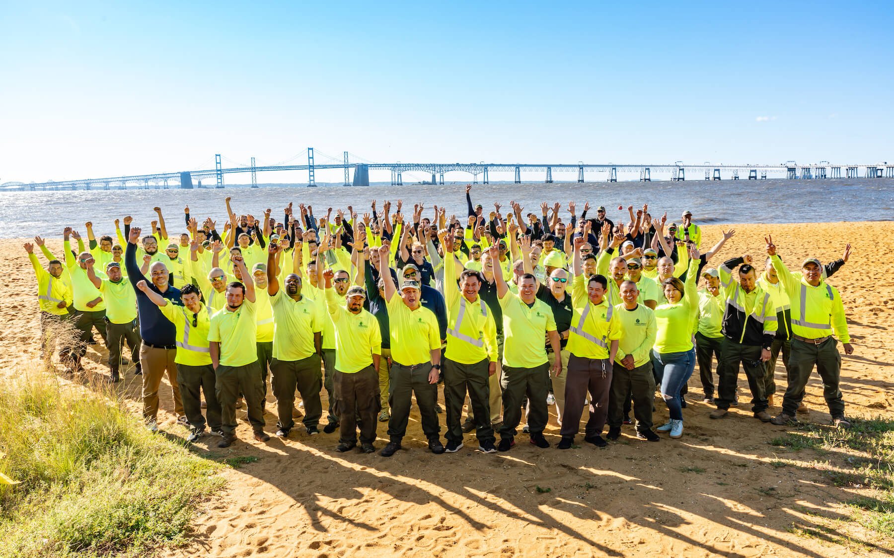 Level Green Sandy Point Event team raising hands 2-1