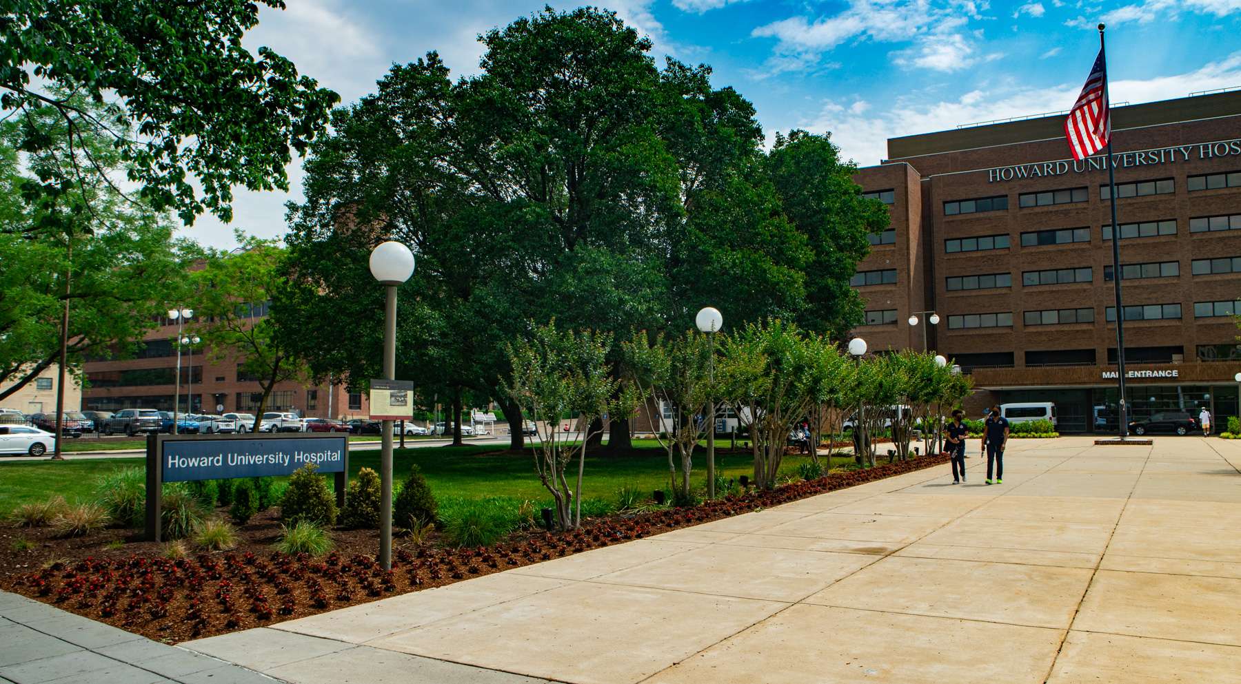 Commercial landscaping Howard University Hospital concrete, shrubs, trees, flowers sign