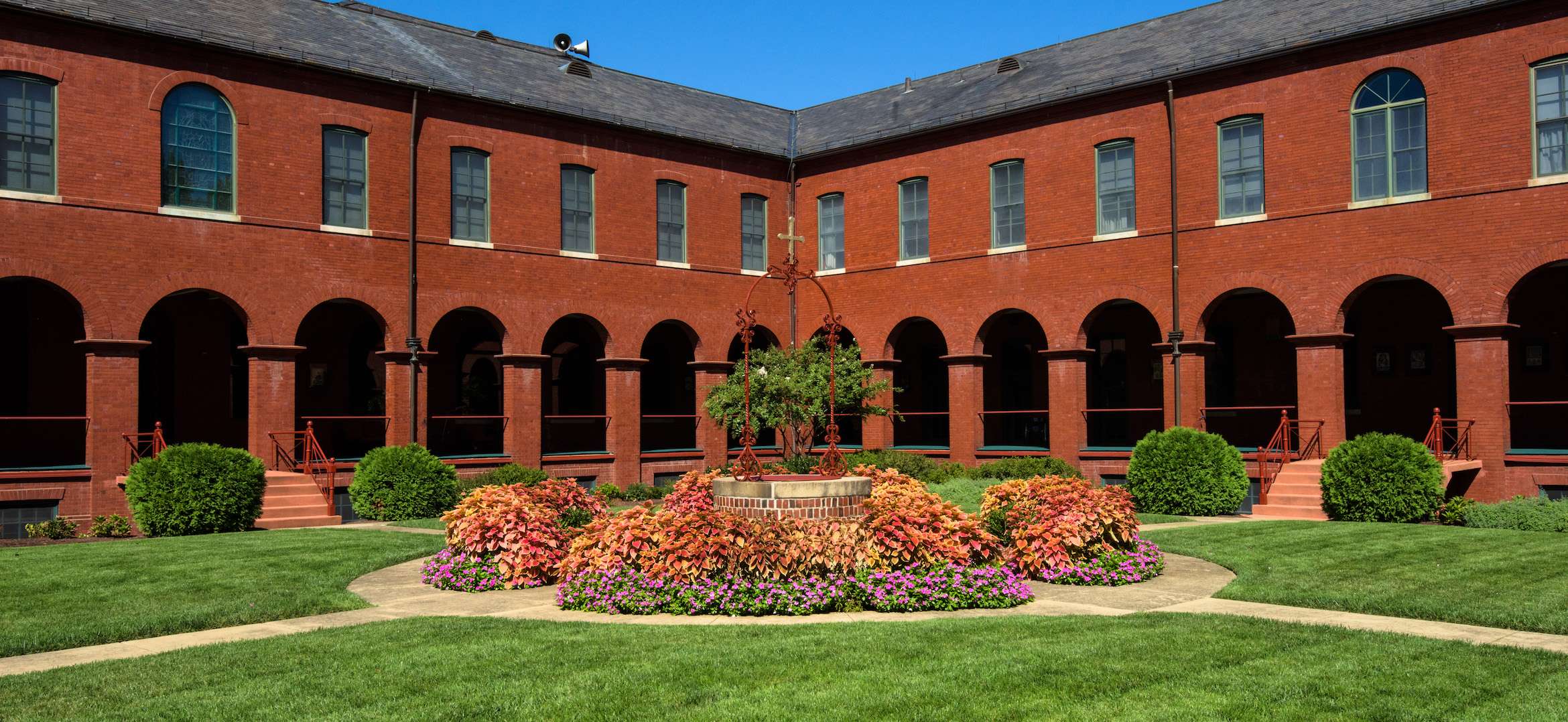 FranciscanMonastery walkway circular planting area bushes flowers church