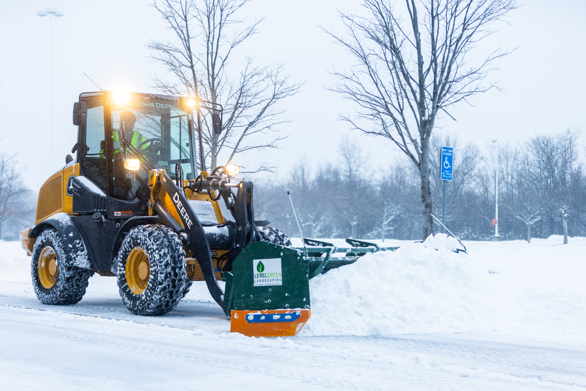 Commercial snow removal crew plowing snow 10